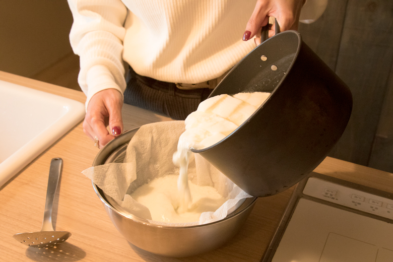 手作りチーズの作り方｜鍋に戻して43℃まで温めたら（お風呂の温度ぐらい）、ざるにキッチンペーパーか料理用のガーゼを敷き、鍋の中身をあけて水気を切る。